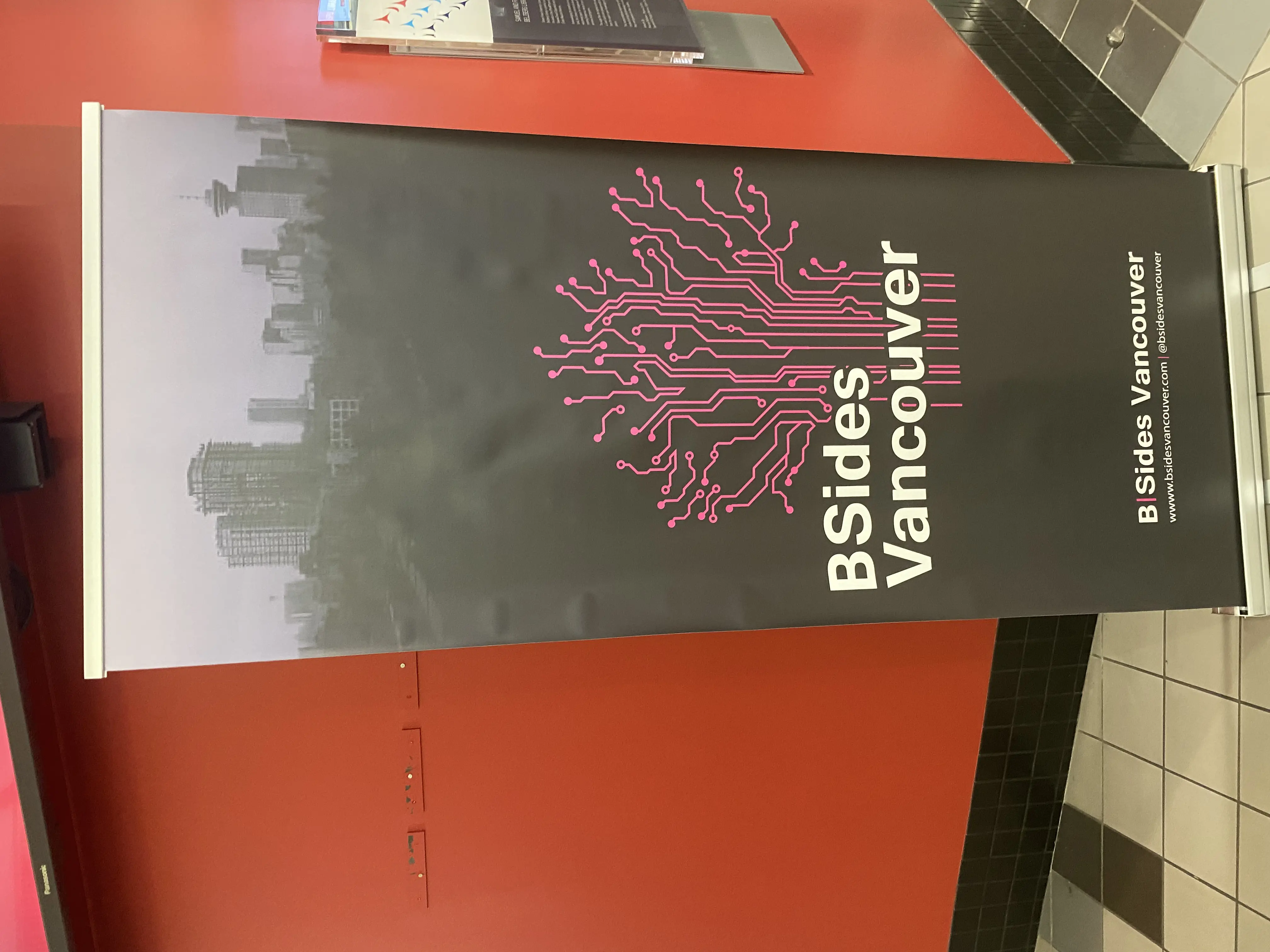 BSides Vancouver 2025 entrance banner with stylized circuit skyline